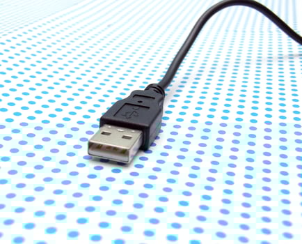 USB cable on dotted background photo