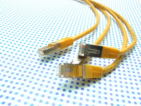 yellow ethernet cable on dotted background photo