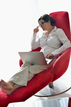 woman using a laptop computer at home photo