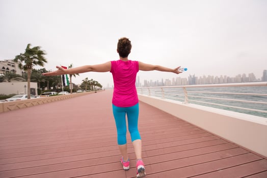 young woman celebrating a successful training run photo