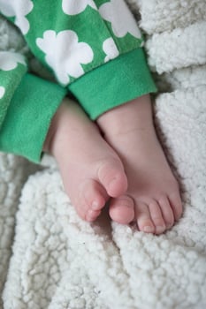 cute little baby playing with hands and smiling photo