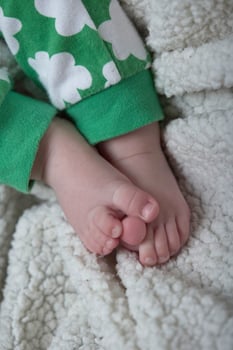 cute little baby playing with hands and smiling photo