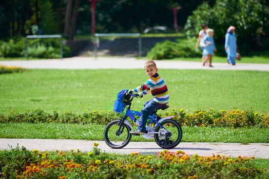 happy boy learning to ride his first bike photo