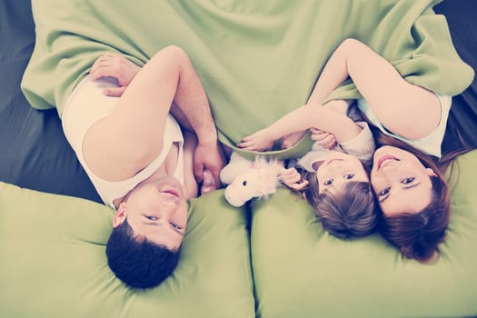 happy family relaxing in bed photo