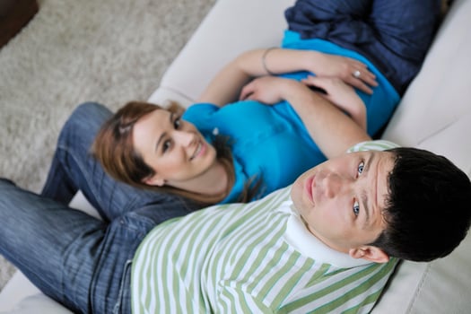 couple relax at home on sofa in living room photo