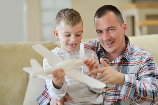 father and son assembling airplane toy photo