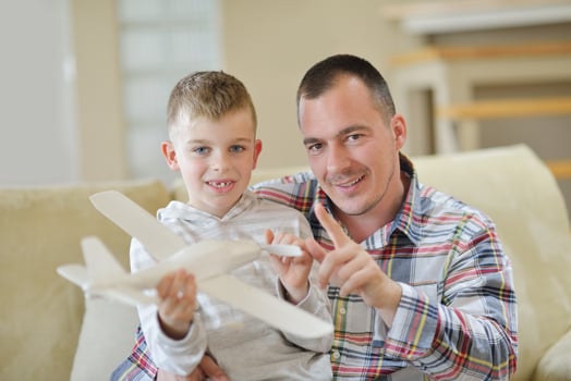 father and son assembling airplane toy photo