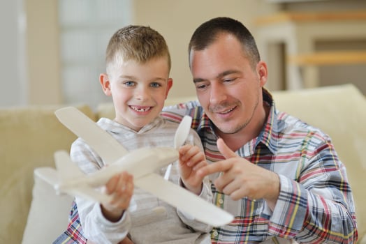 father and son assembling airplane toy photo