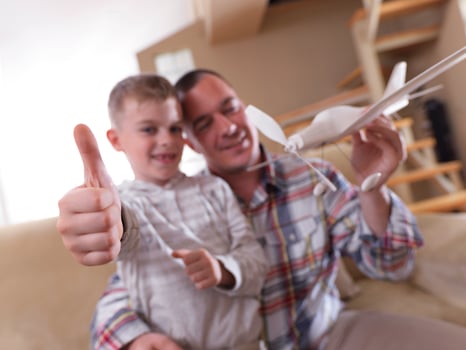 father and son assembling airplane toy photo