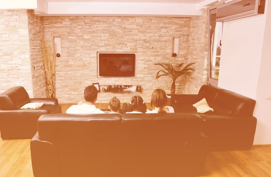 family wathching flat tv at modern home indoor photo