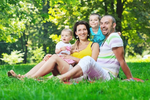 happy young couple with their children have fun at park photo
