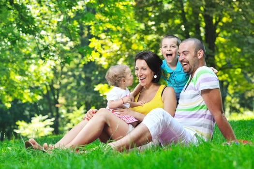 happy young couple with their children have fun at park photo