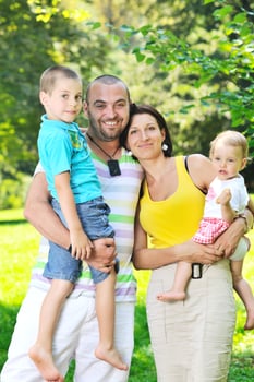 happy young couple with their children have fun at park photo