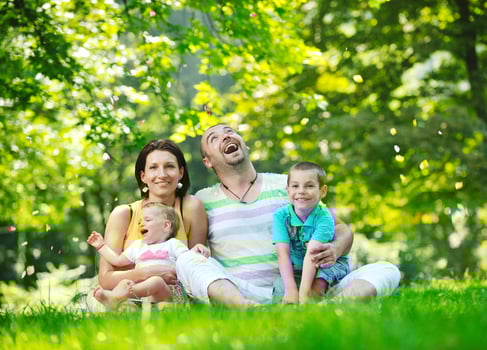 happy young couple with their children have fun at park photo
