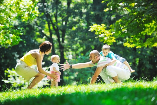 happy young couple with their children have fun at park photo