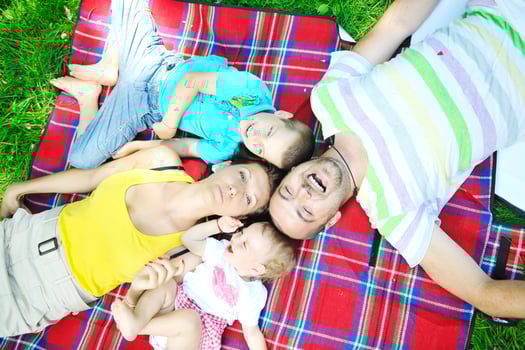 happy young couple with their children have fun at park photo