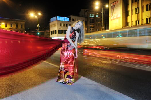elegant woman on city street at night photo
