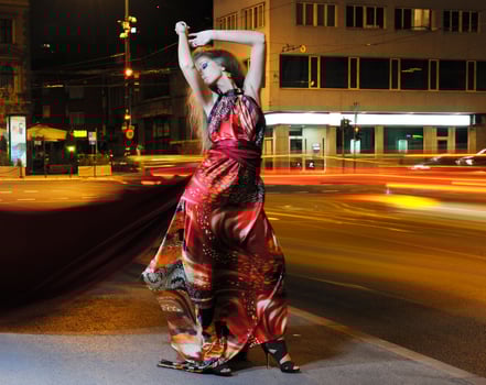 elegant woman on city street at night photo