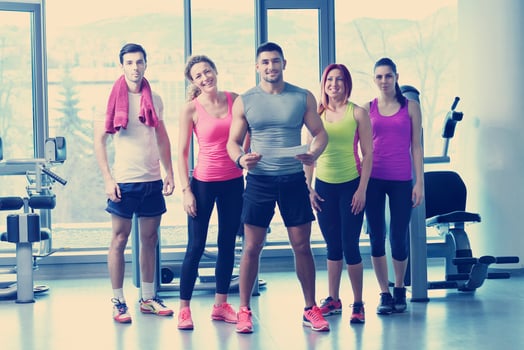 Group of people exercising at the gym photo
