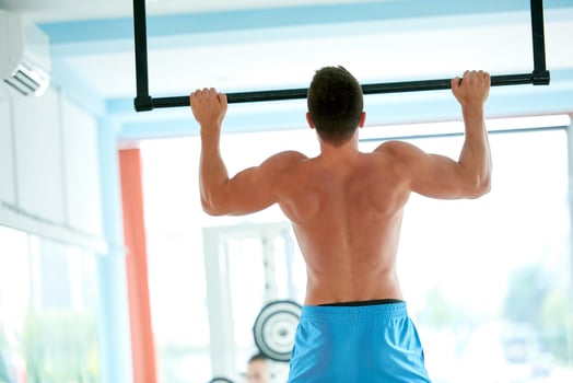 handsome young mand working out in gym photo
