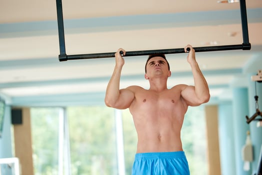 handsome young mand working out in gym photo