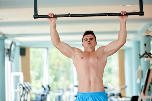 handsome young mand working out in gym photo