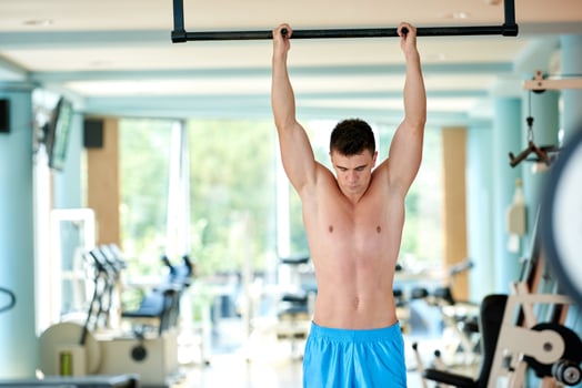 handsome young mand working out in gym photo