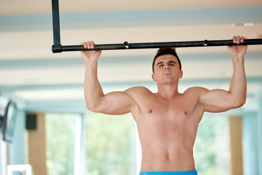 handsome young mand working out in gym photo