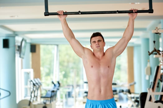 handsome young mand working out in gym photo