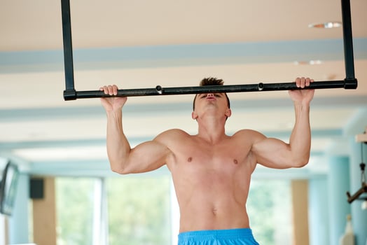 handsome young mand working out in gym photo