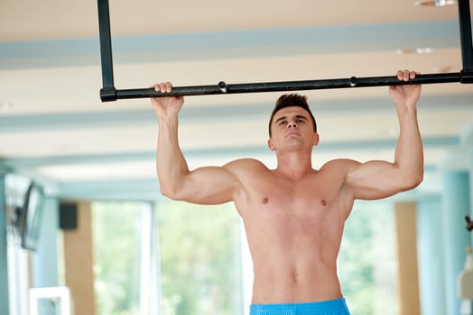 handsome young mand working out in gym photo