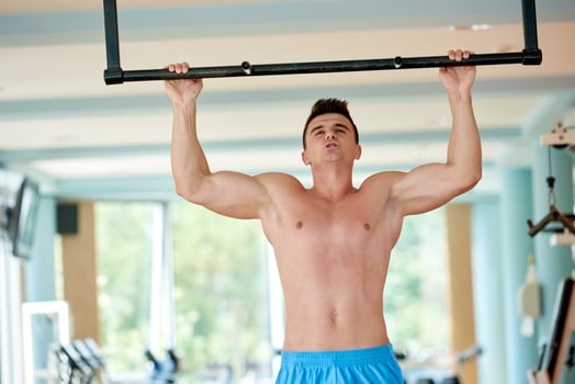 handsome young mand working out in gym photo