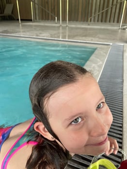 Smiling child in goggles swim, dive in the pool with fun - jump deep down underwater. Healthy lifestyle, people water sport activity on summers. photo