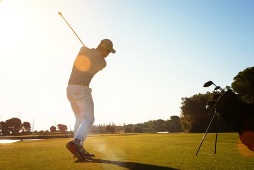 golf player hitting shot with club photo