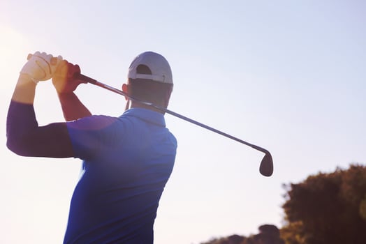 golf player hitting shot photo