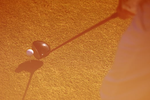 top view of golf club and ball in grass photo