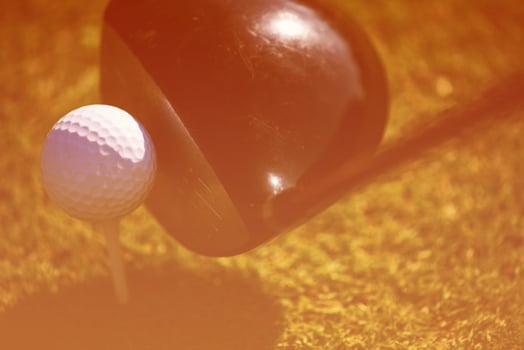 top view of golf club and ball in grass photo