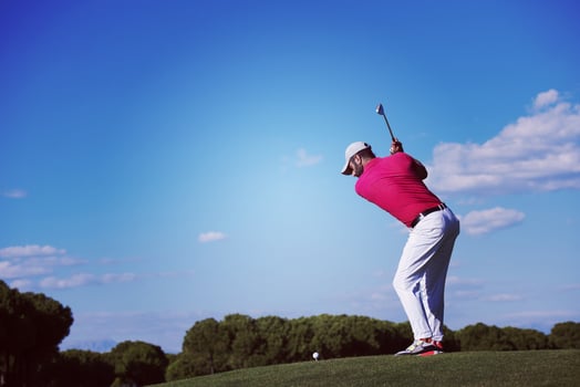 golf player hitting long shot photo