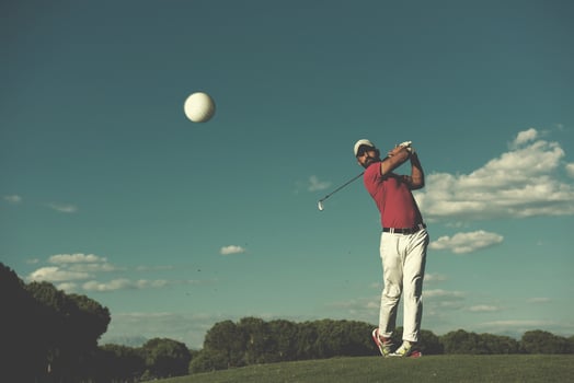 golf player hitting long shot photo