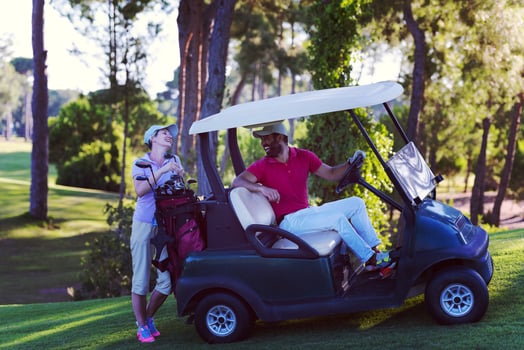 couple in buggy on golf course photo