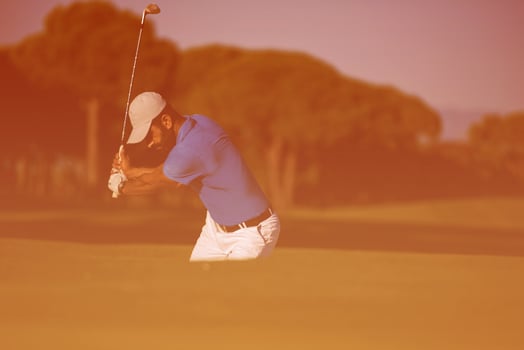 pro golfer hitting a sand bunker shot photo
