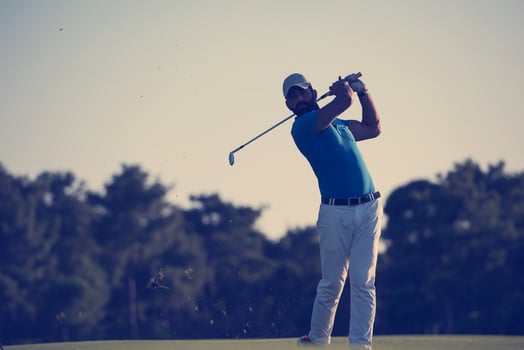 golfer hitting long shot photo