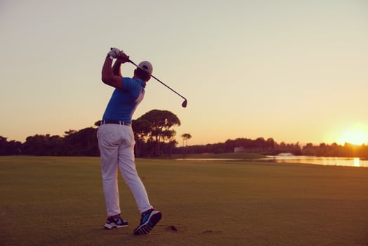 golfer hitting long shot photo
