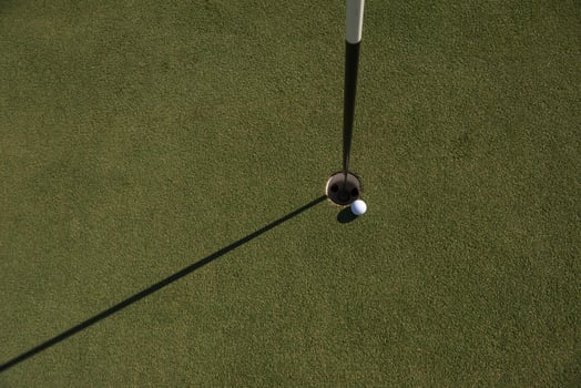 top view of golf ball in the hole photo