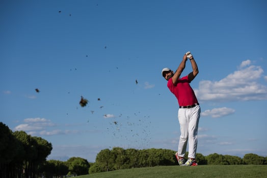 golf player hitting long shot photo