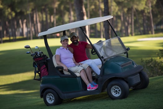 couple in buggy on golf course photo