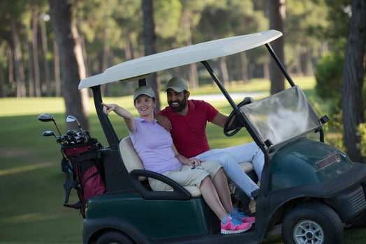 couple in buggy on golf course photo