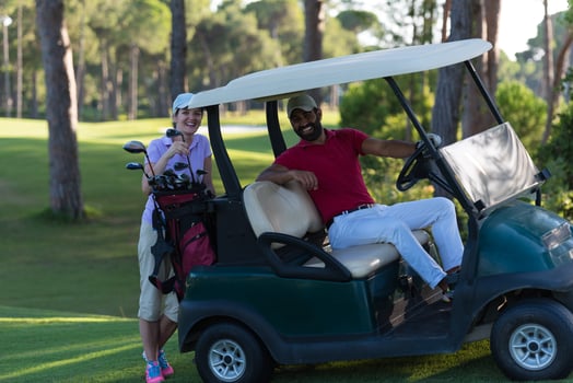 couple in buggy on golf course photo