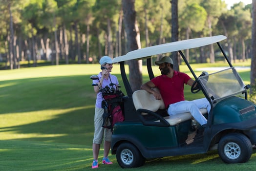 couple in buggy on golf course photo