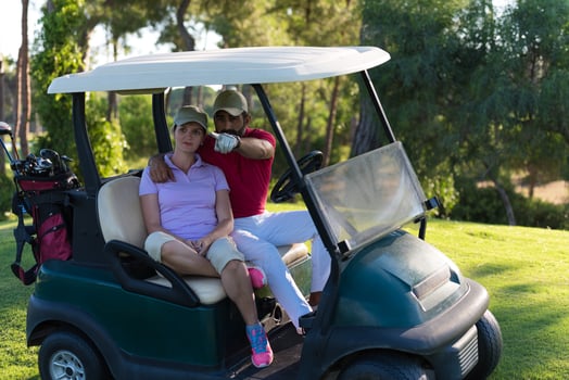 couple in buggy on golf course photo